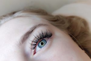 Lash extensions in beauty salon macro eye . High quality photo